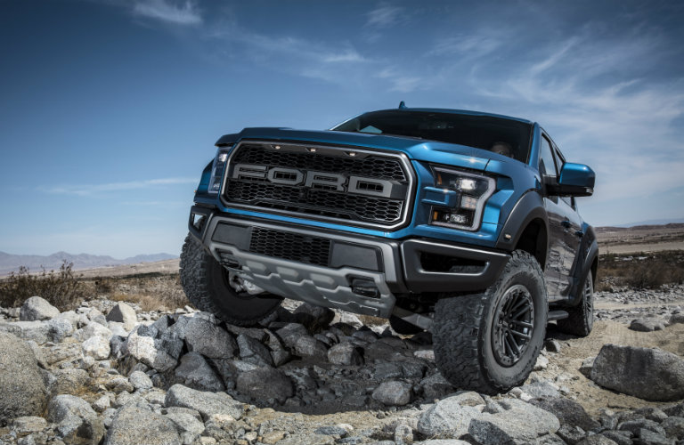 2019 Ford F-150 Raptor driving on rocks