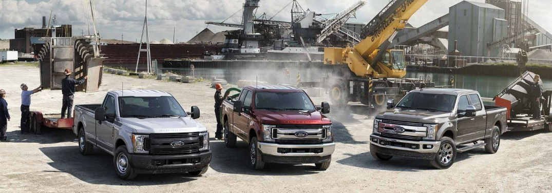 2019 Ford F-150 vs F-250 vs F-350 with image of the 2019 Ford Super Duty lineup at a busy work site
