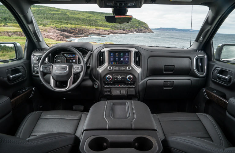 Interior view of black seating and steering wheel & dashboard of a 2019 GMC Sierra 1500